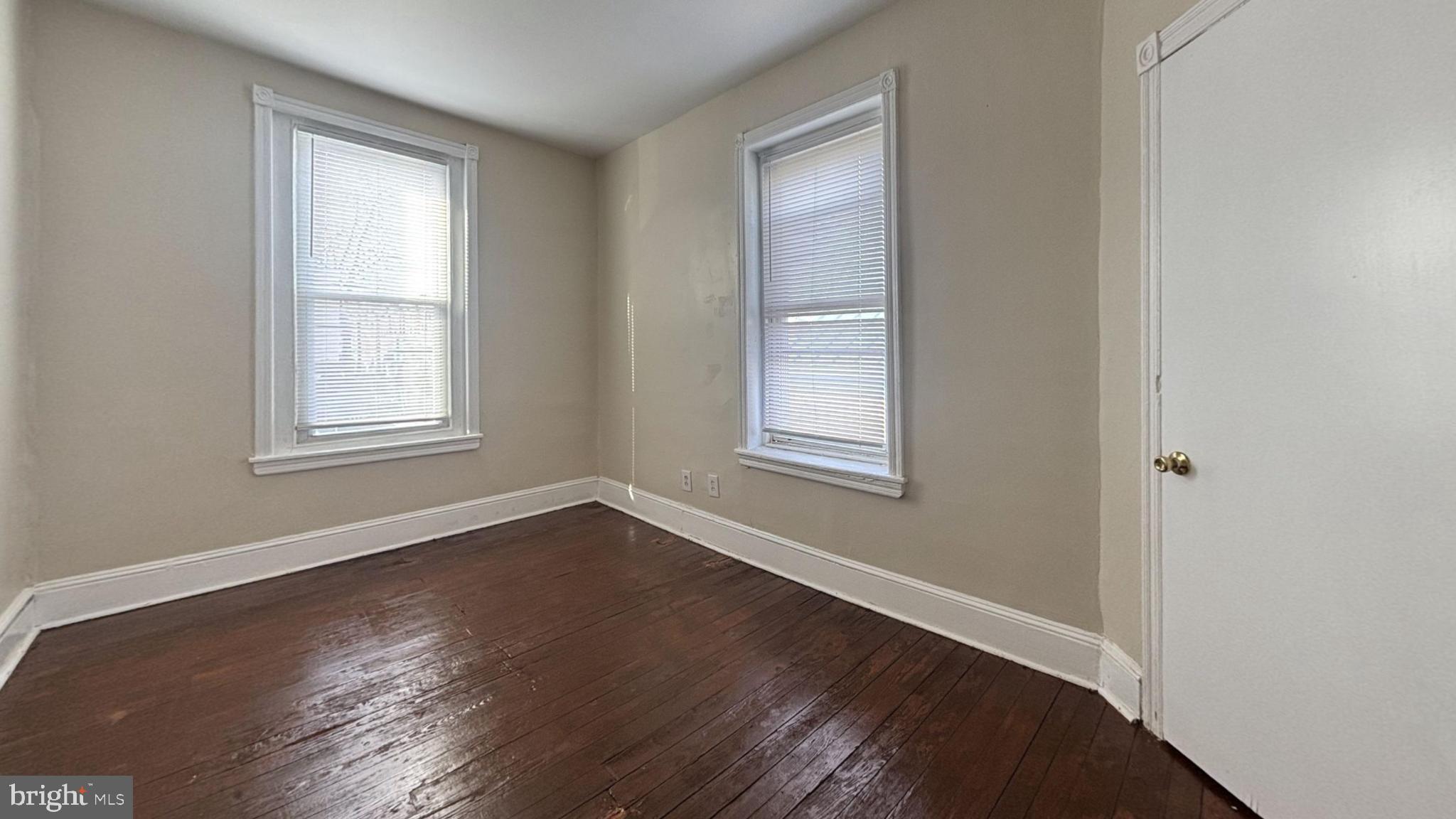 5471 Delancey Street Philadelphia, PA 19143 - Photo 6 of 9 an empty room with wooden floor and windows