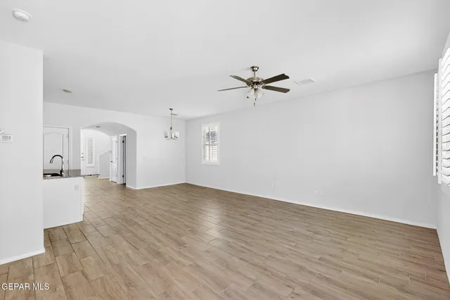 a kitchen with granite countertop a sink stove and refrigerator