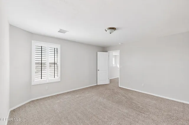 a white painted wall with a window in it