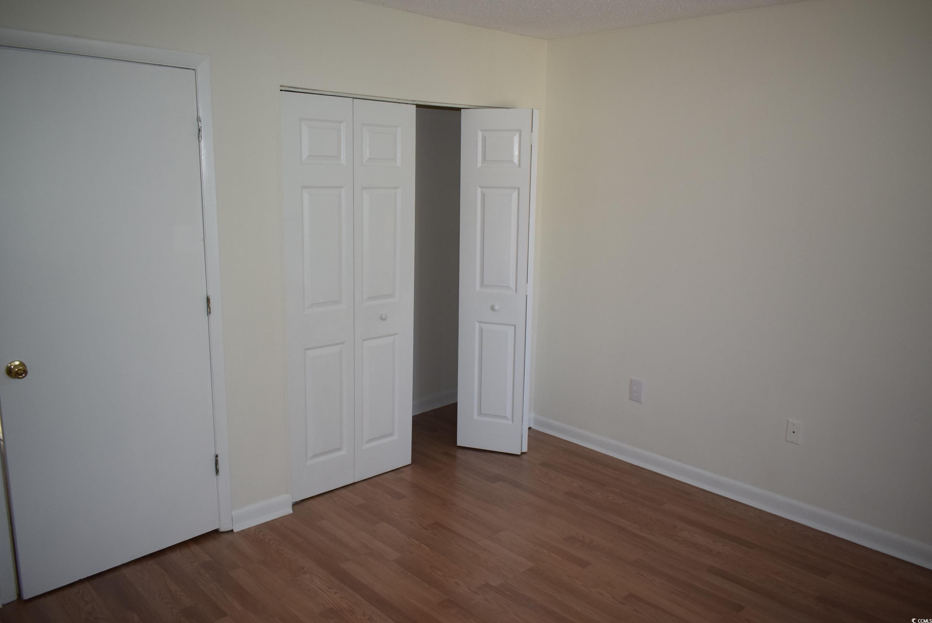 1208 Pinegrove Drive, Unit H Myrtle Beach, SC 29577 - Photo 18 of 18 Spare room featuring baseboards and dark wood-style flooring