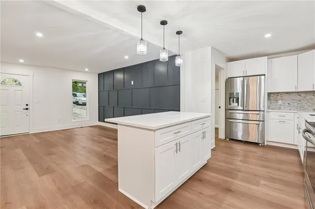 a kitchen with white cabinets and stainless steel appliances