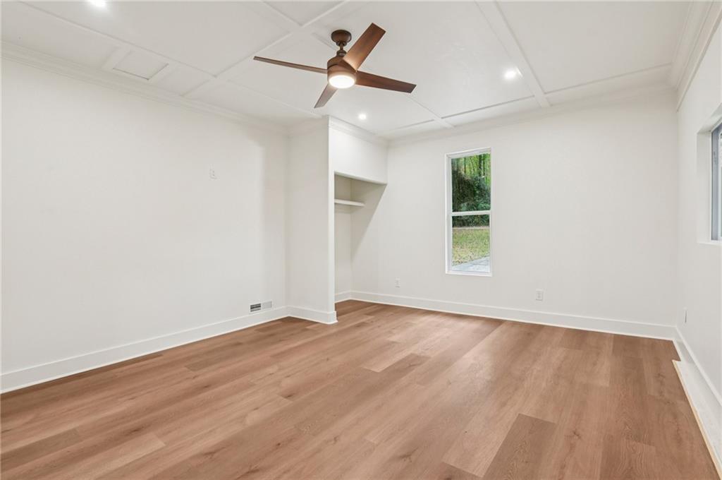 24 McClure Road Temple, GA 30179 - Photo 15 of 41 an empty room with wooden floor ceiling fan and windows