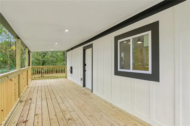 a view of a balcony with wooden floor
