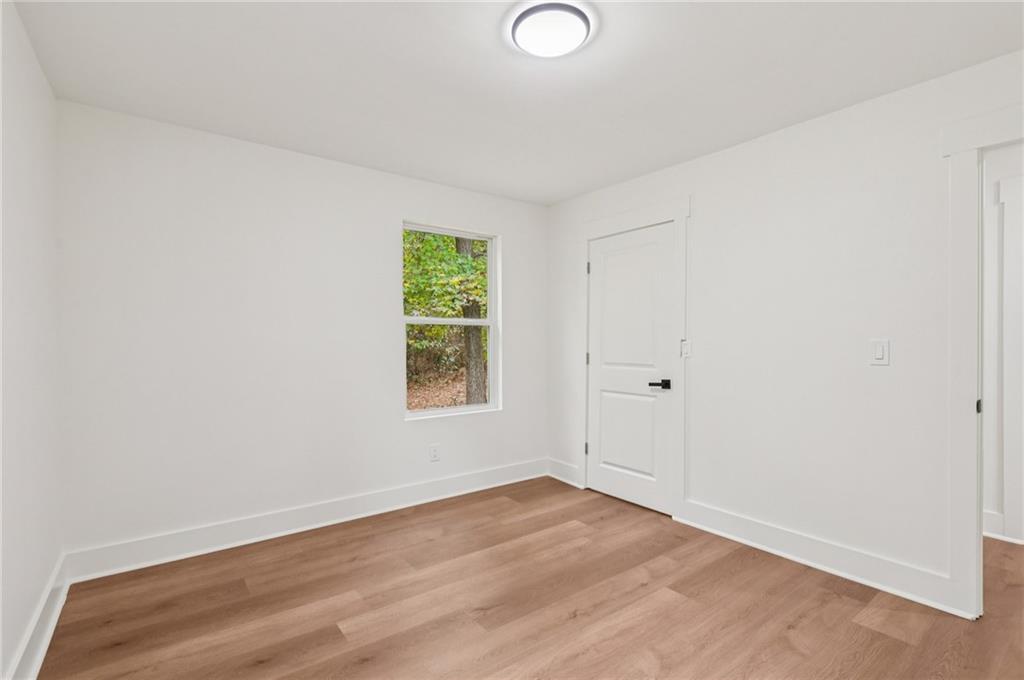 24 McClure Road Temple, GA 30179 - Photo 30 of 41 an empty room with wooden floor and windows