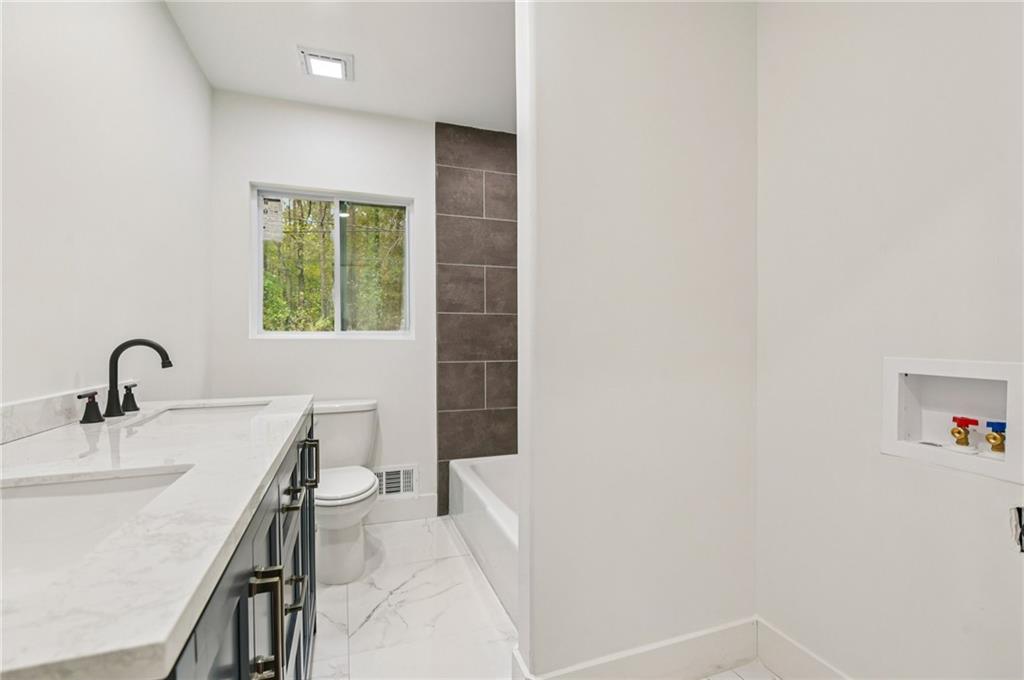 24 McClure Road Temple, GA 30179 - Photo 33 of 41 a bath room with a sink and a bath tub