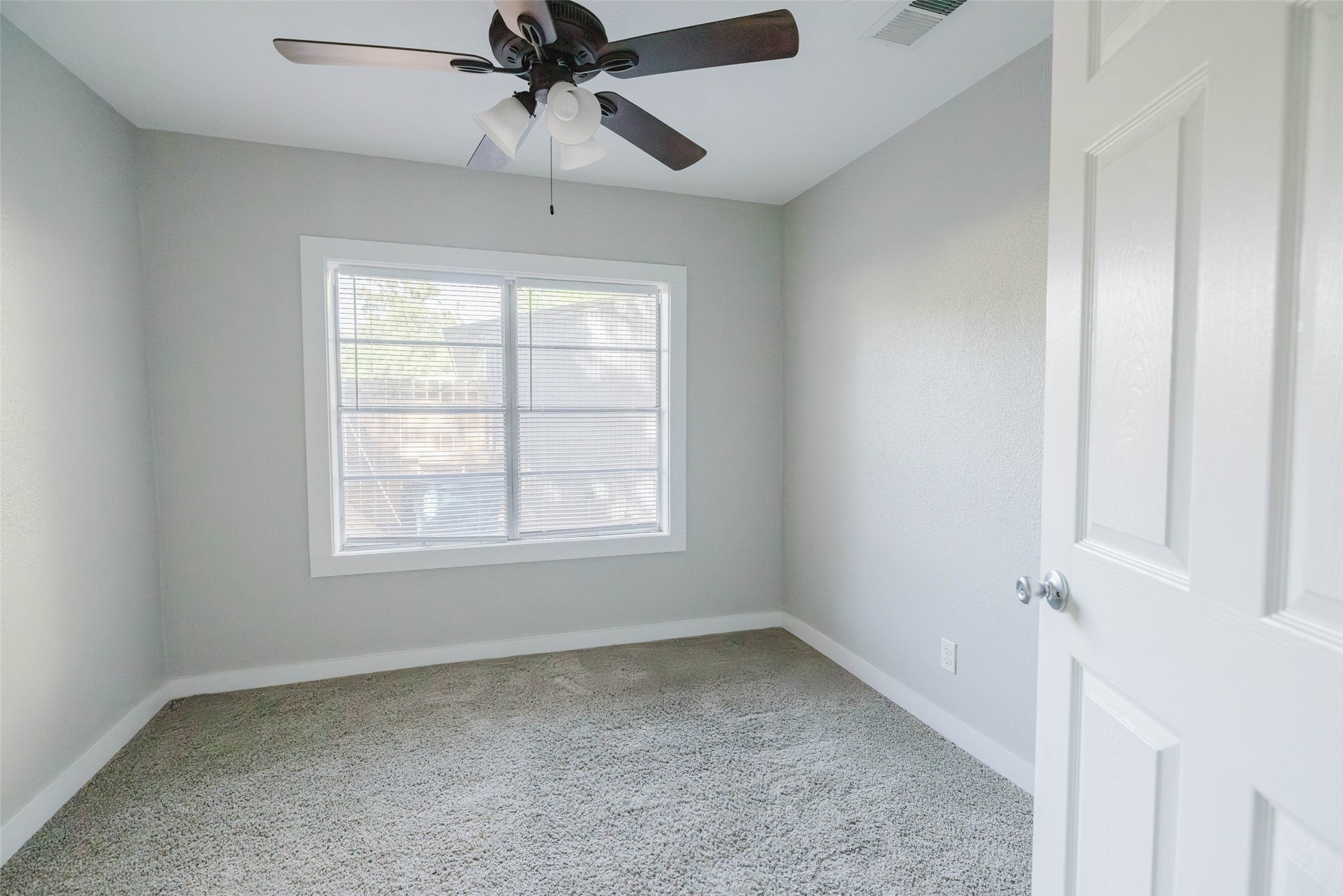 2518 Daugherty Street Waller, TX 77484 - Photo 12 of 32 an empty room with a window and a fan