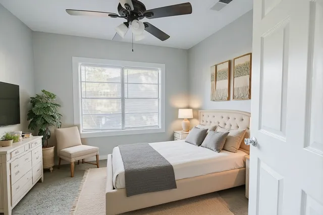 a bedroom with a bed and a window