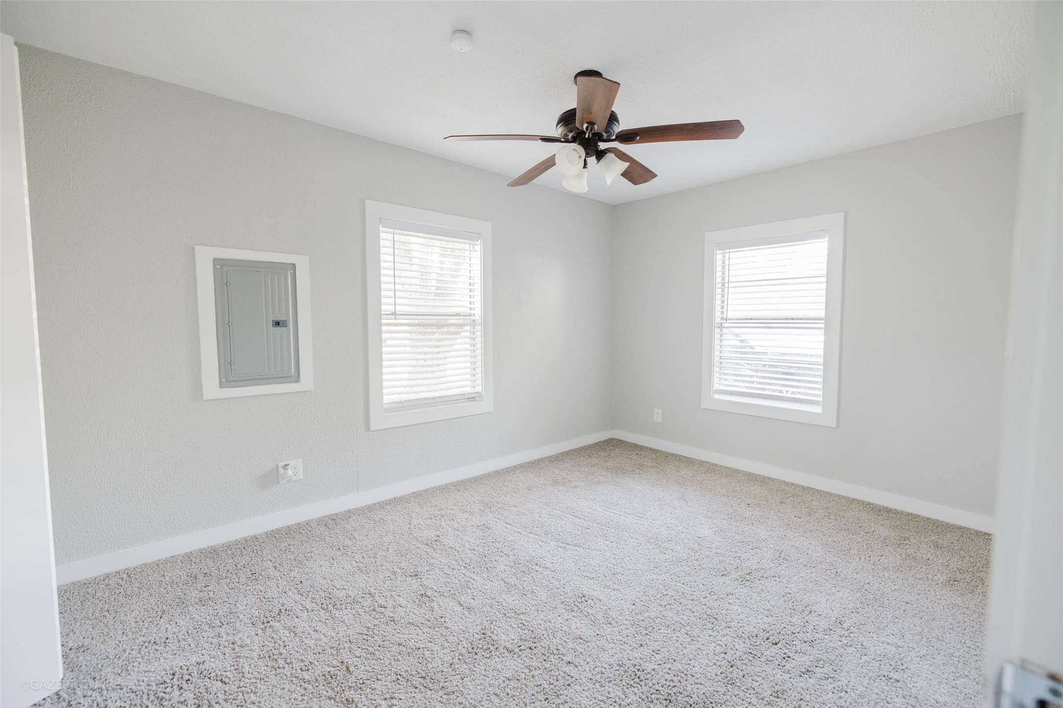 2518 Daugherty Street Waller, TX 77484 - Photo 14 of 32 a view of a livingroom with a ceiling fan & windows