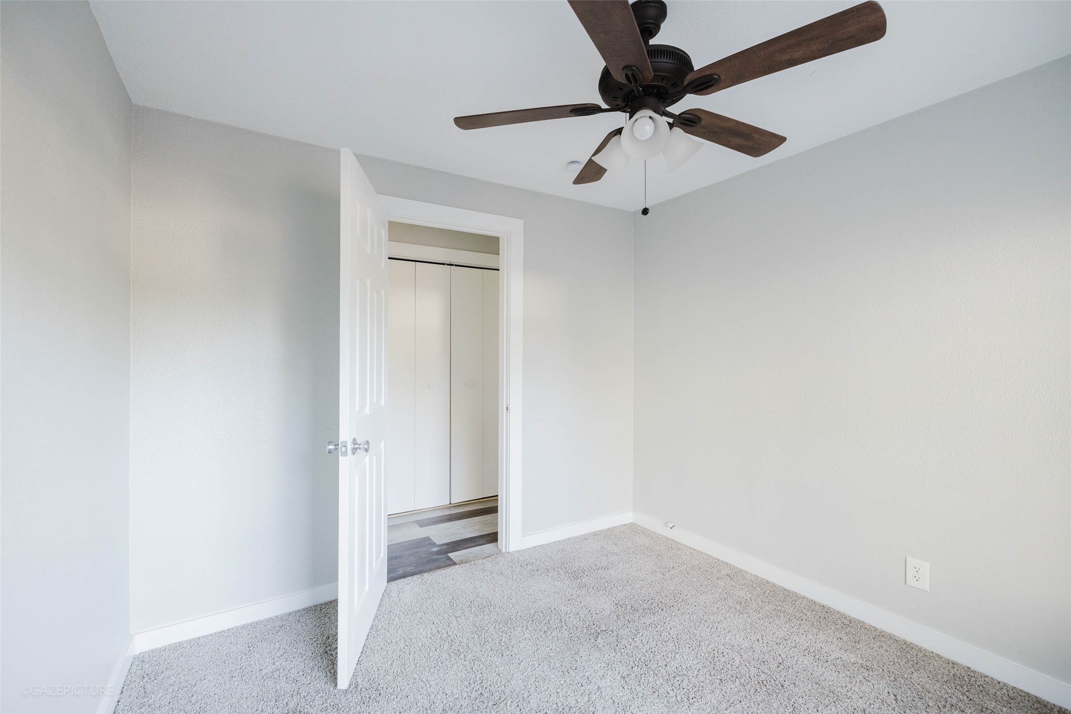 2518 Daugherty Street Waller, TX 77484 - Photo 29 of 32 an empty room with a ceiling fan and carpet