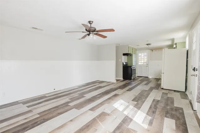 a view of a room with a ceiling fan
