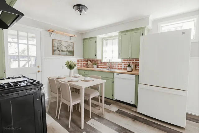 a kitchen with a table and chairs in it