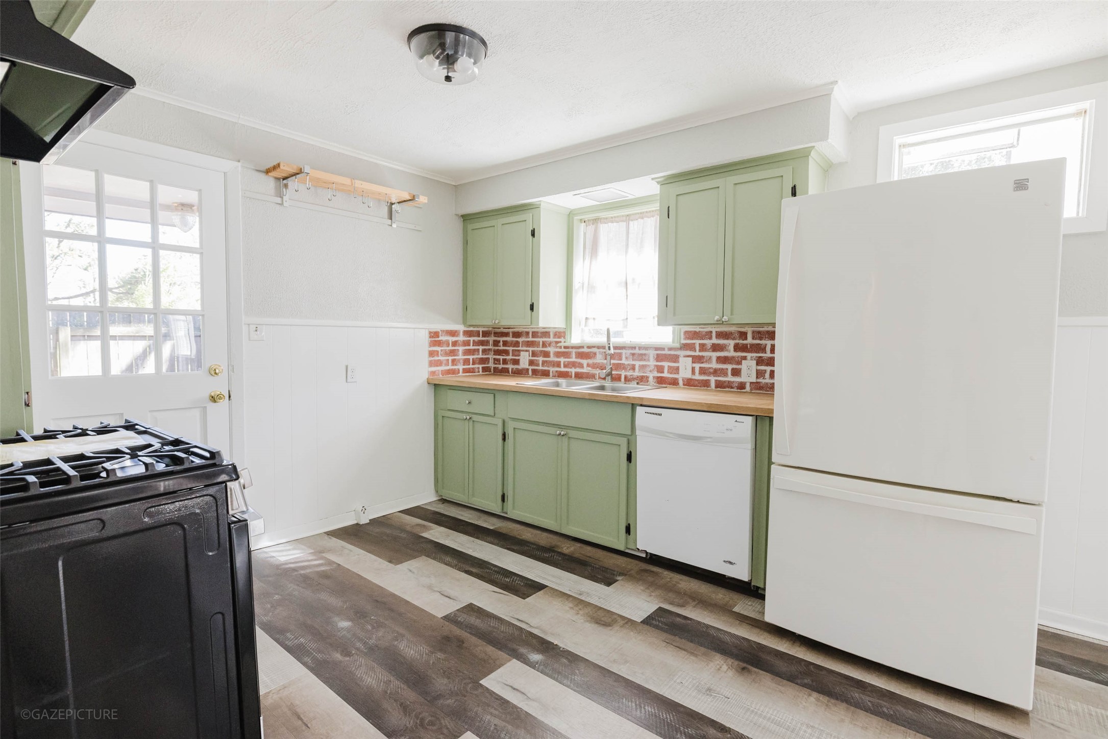 2518 Daugherty Street Waller, TX 77484 - Photo 7 of 32 a kitchen with a stove and a refrigerator