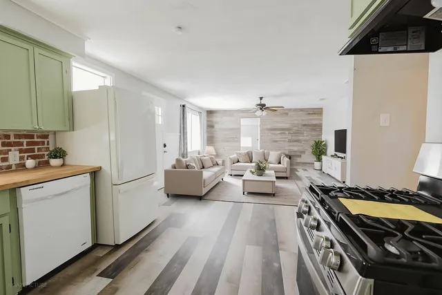 a kitchen with sink stove and refrigerator