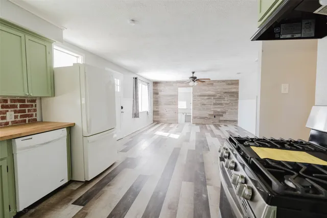 a kitchen with granite countertop a stove and a refrigerator