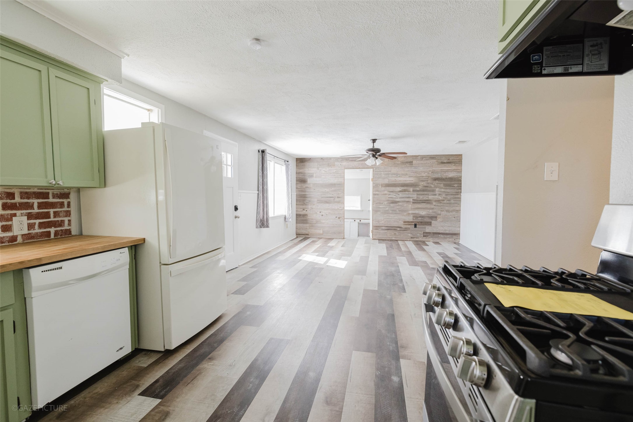 2518 Daugherty Street Waller, TX 77484 - Photo 9 of 32 a kitchen with granite countertop a stove and a refrigerator