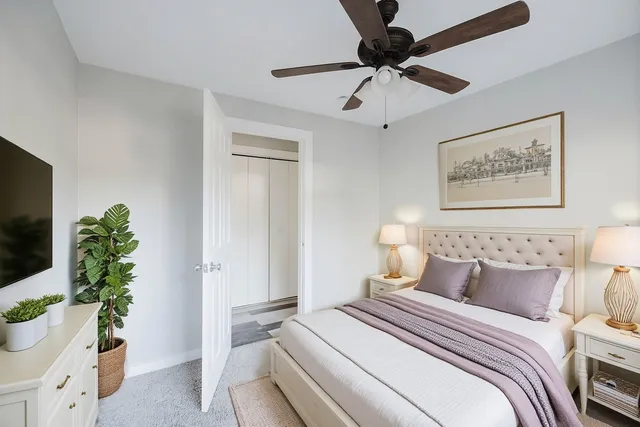 a bedroom with a bed and a potted plant