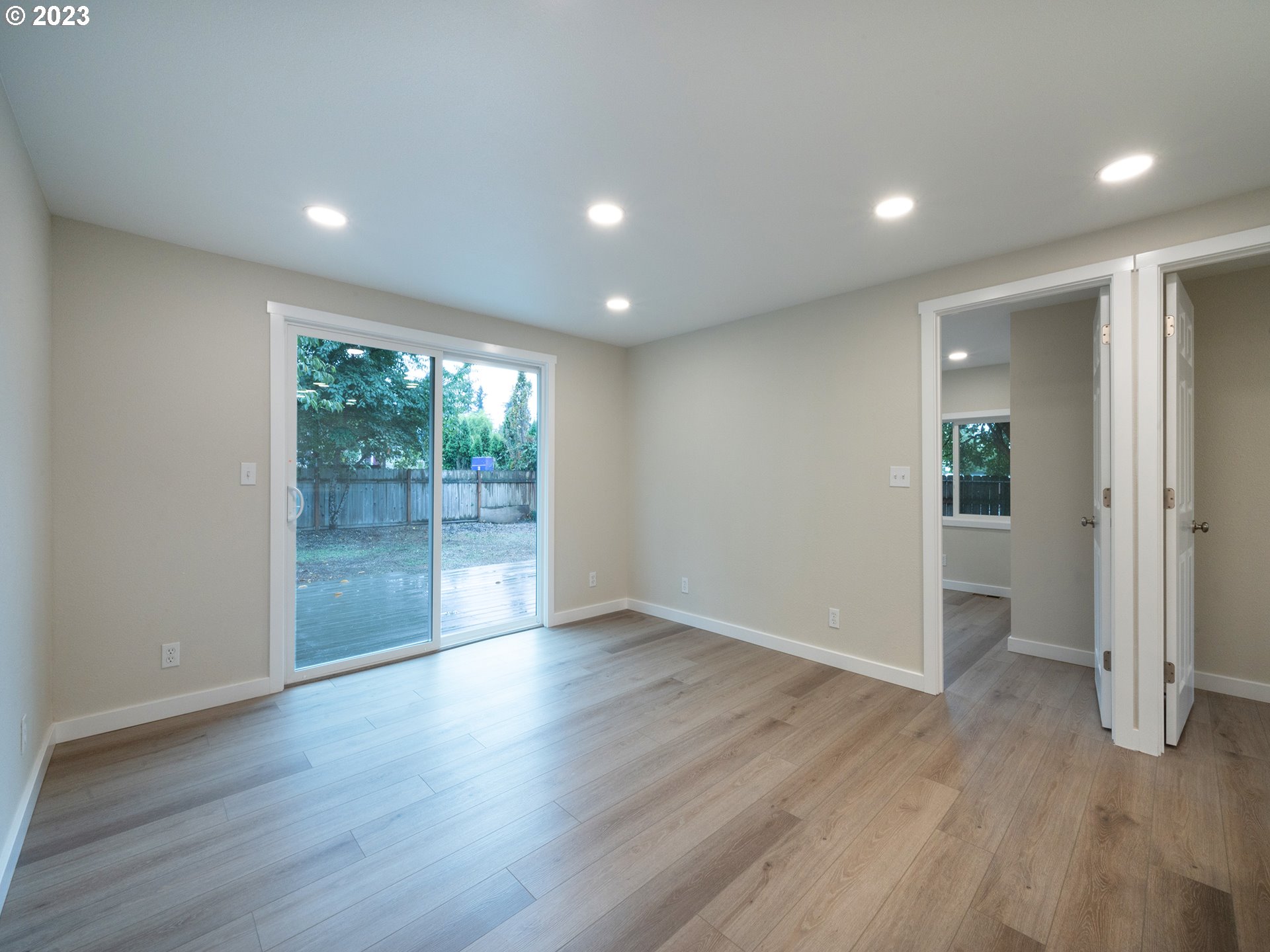 5131 Daisy Street Springfield, OR 97478 - Photo 12 of 45 an empty room with wooden floor and windows