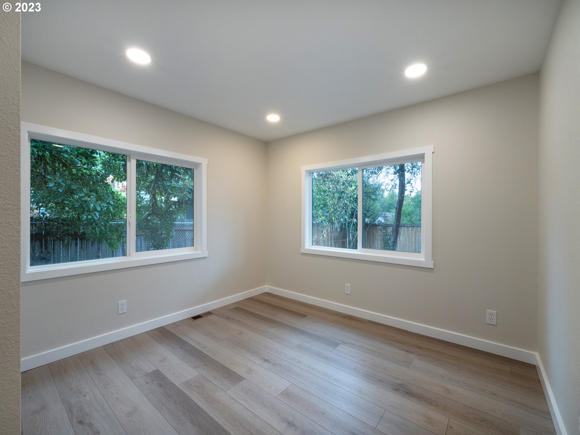 5131 Daisy Street Springfield, OR 97478 - Photo 14 of 45 an empty room with wooden floor and windows
