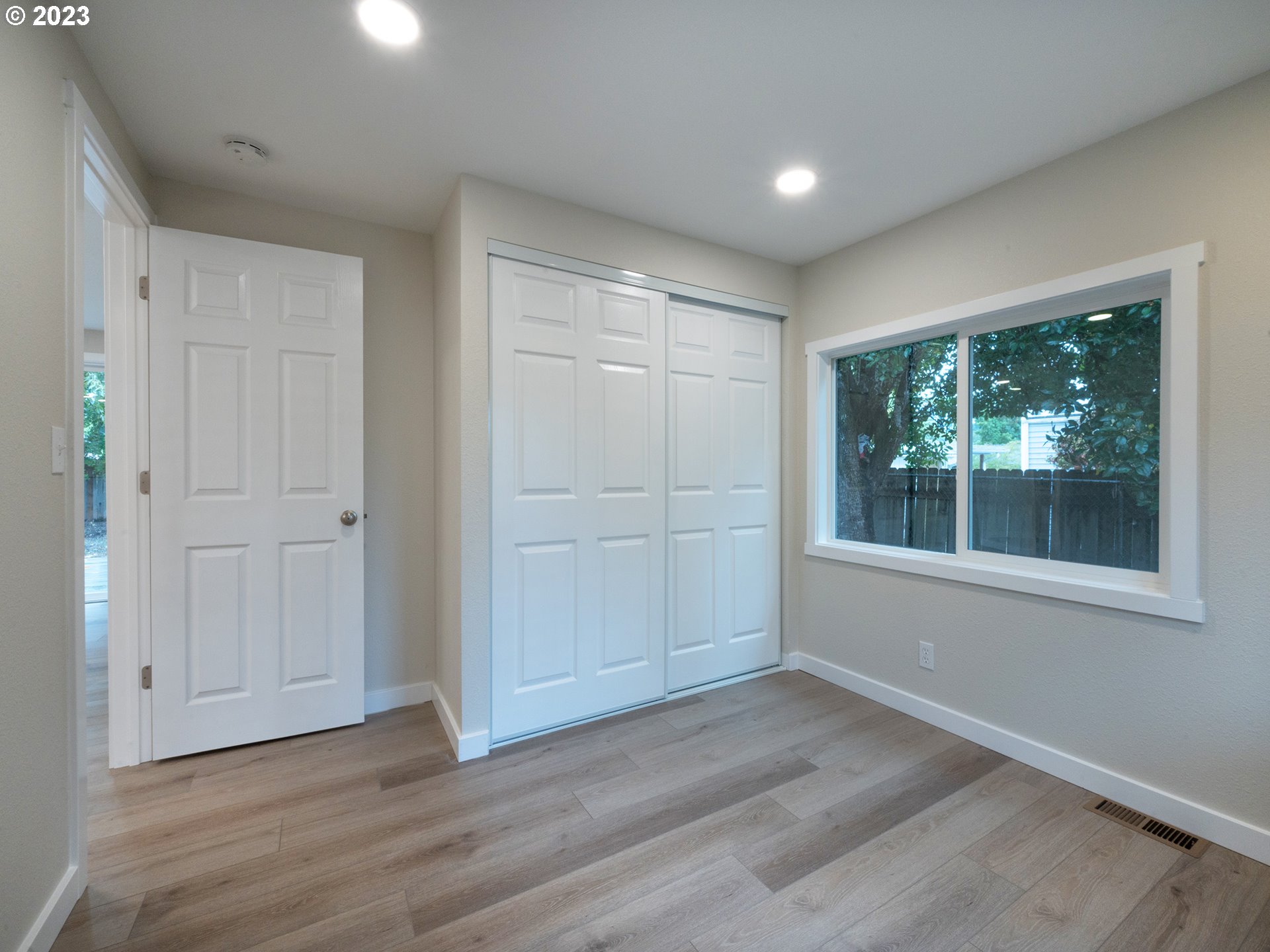 5131 Daisy Street Springfield, OR 97478 - Photo 15 of 45 an empty room with wooden floor and windows