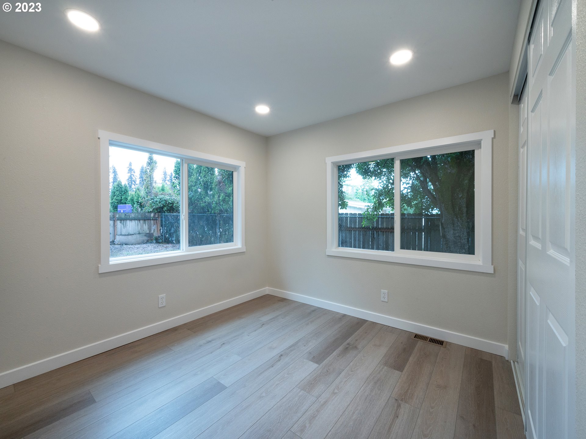 5131 Daisy Street Springfield, OR 97478 - Photo 19 of 45 an empty room with wooden floor and windows