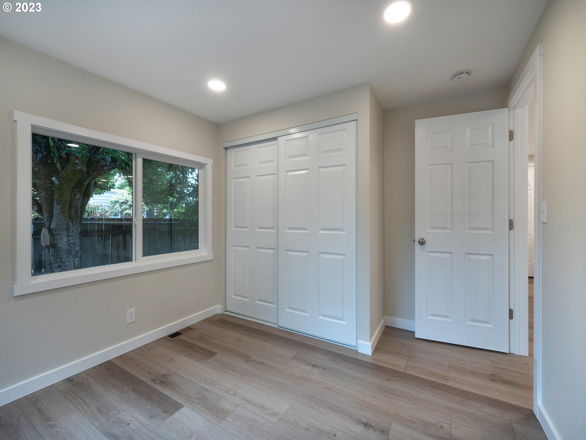 5131 Daisy Street Springfield, OR 97478 - Photo 20 of 45 an empty room with wooden floor and windows