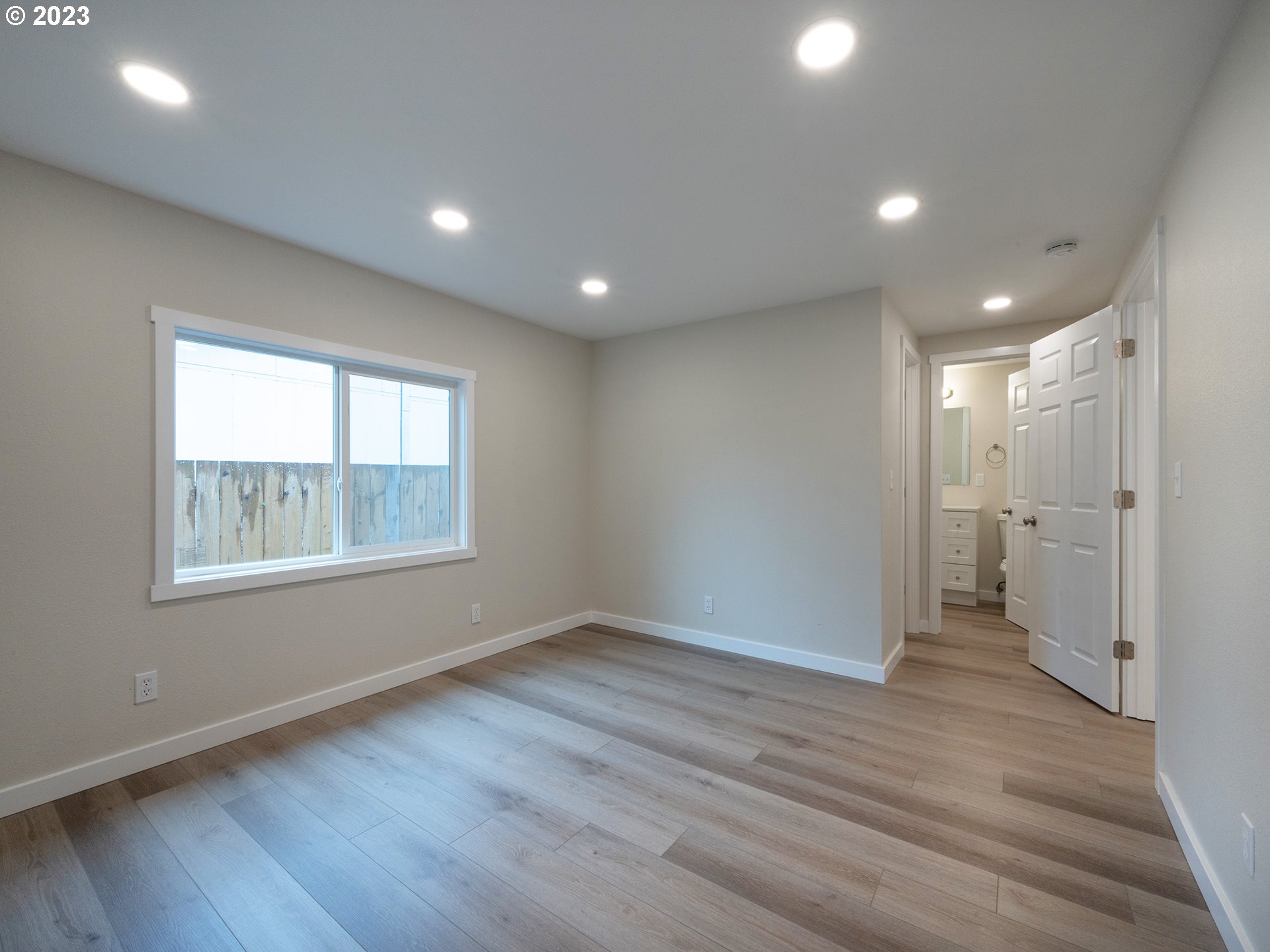 5131 Daisy Street Springfield, OR 97478 - Photo 21 of 45 a view of an empty room with wooden floor and a window