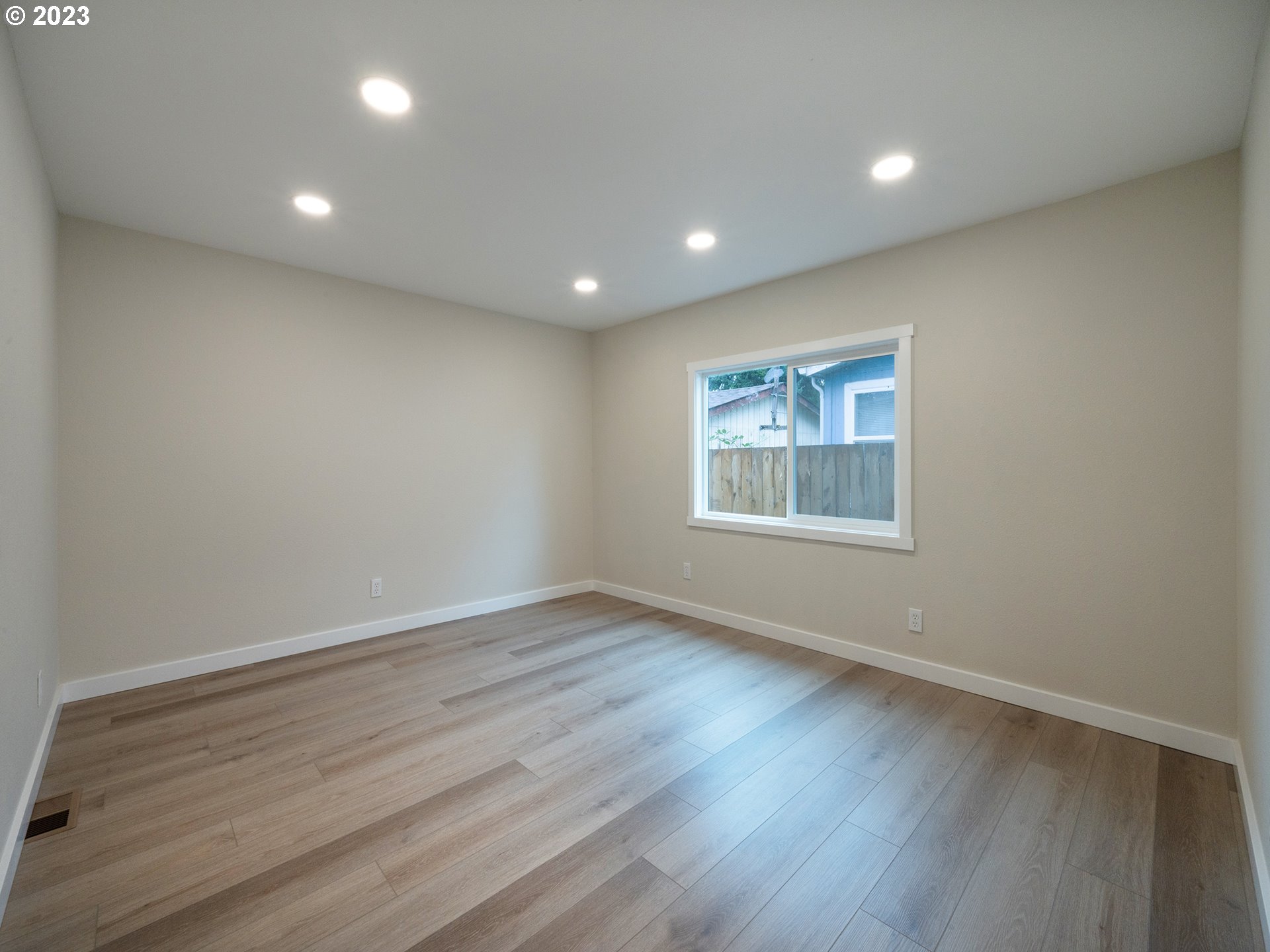 5131 Daisy Street Springfield, OR 97478 - Photo 22 of 45 an empty room with wooden floor and windows