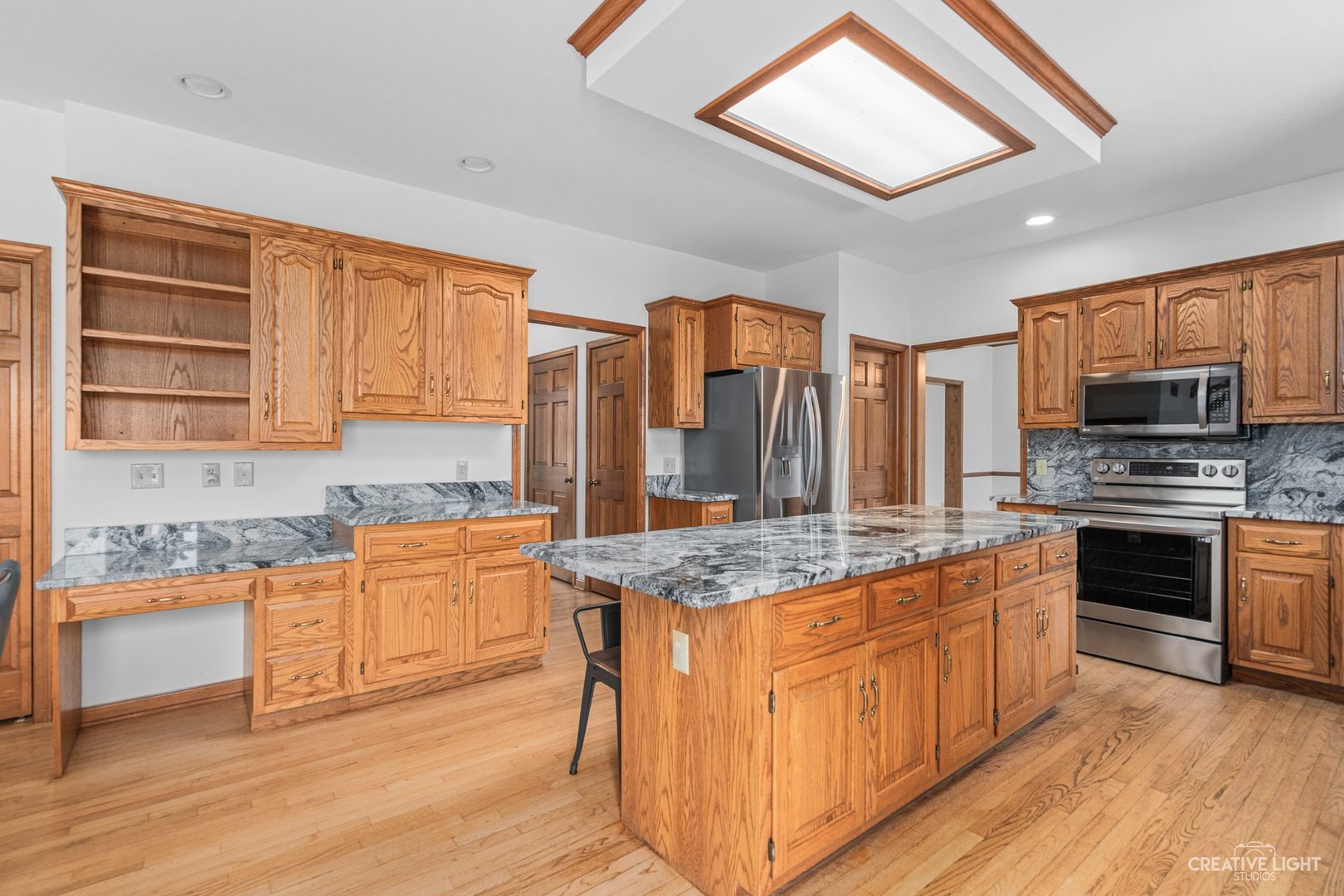 980 Eldamain Road Plano, IL 60545 - Photo 12 of 27 a kitchen with stainless steel appliances granite countertop a stove sink and cabinets
