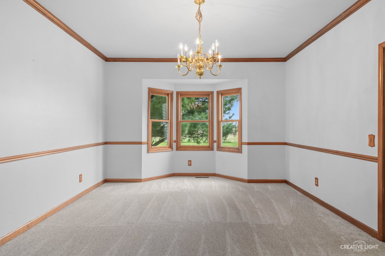 980 Eldamain Road Plano, IL 60545 - Photo 17 of 27 a view of an empty room with chandelier