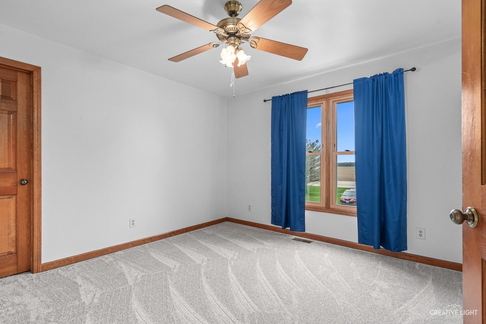 980 Eldamain Road Plano, IL 60545 - Photo 19 of 27 a view of an empty room with window and chandelier fan