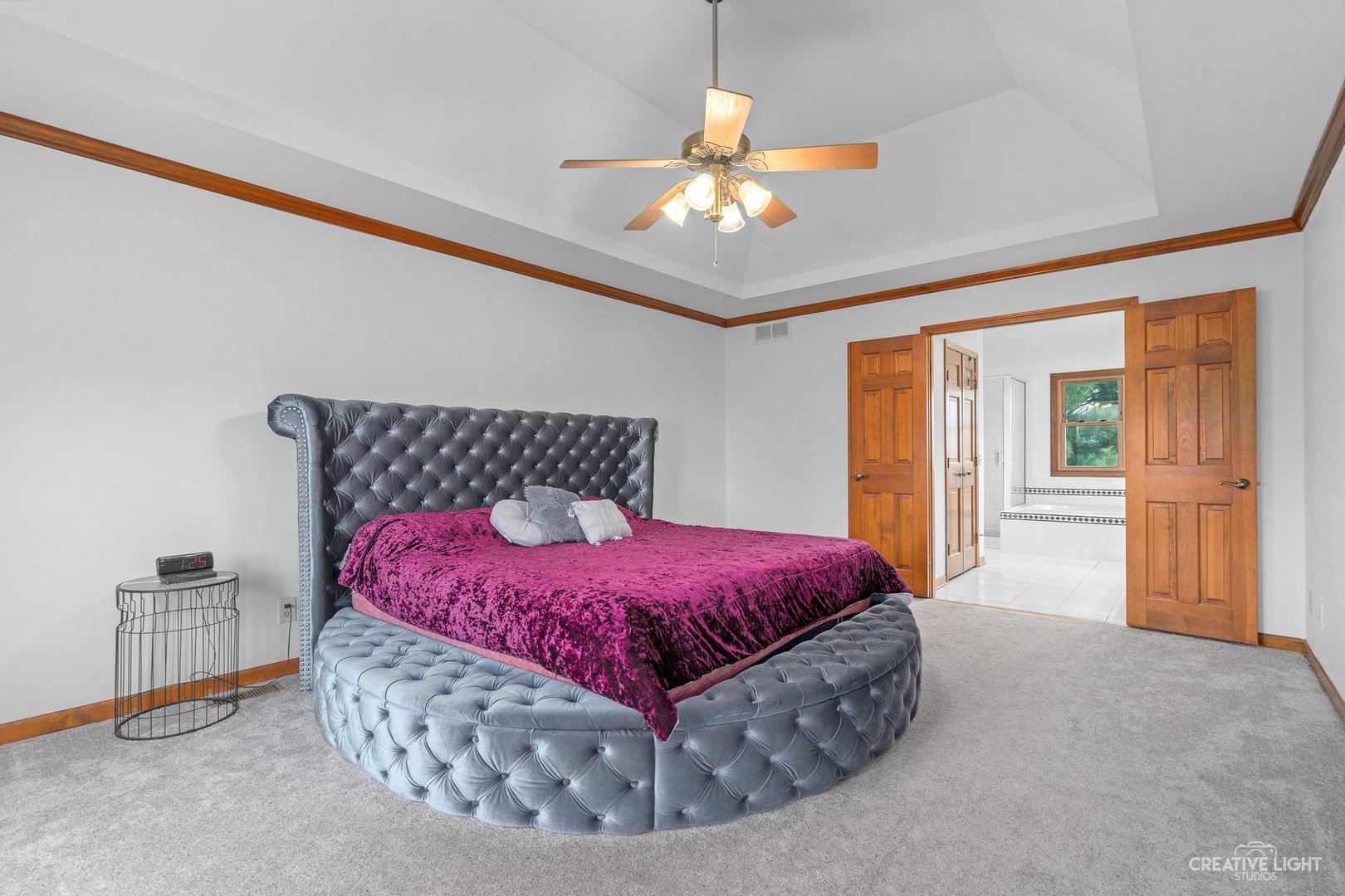 980 Eldamain Road Plano, IL 60545 - Photo 21 of 27 a bedroom with a bed and a chandelier