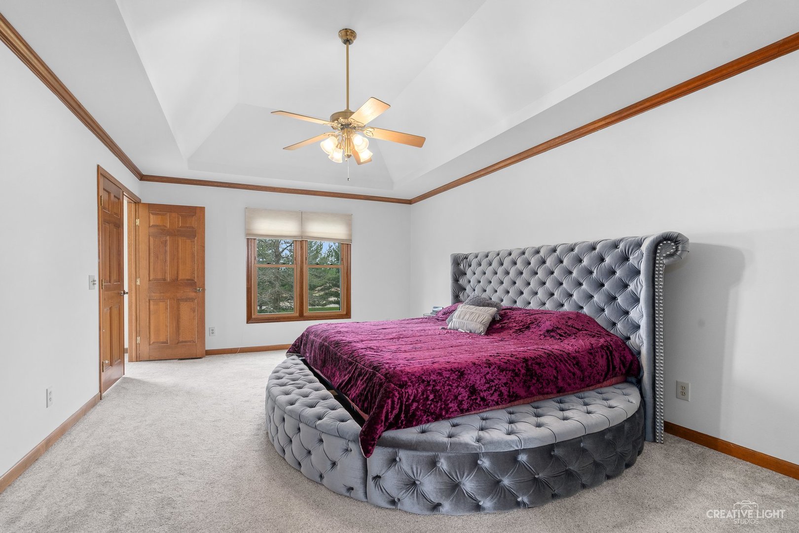 980 Eldamain Road Plano, IL 60545 - Photo 22 of 27 a bed room with a bed and a chandelier