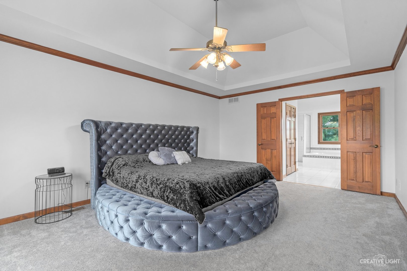 980 Eldamain Road Plano, IL 60545 - Photo 23 of 27 a bedroom with a bed and a chandelier