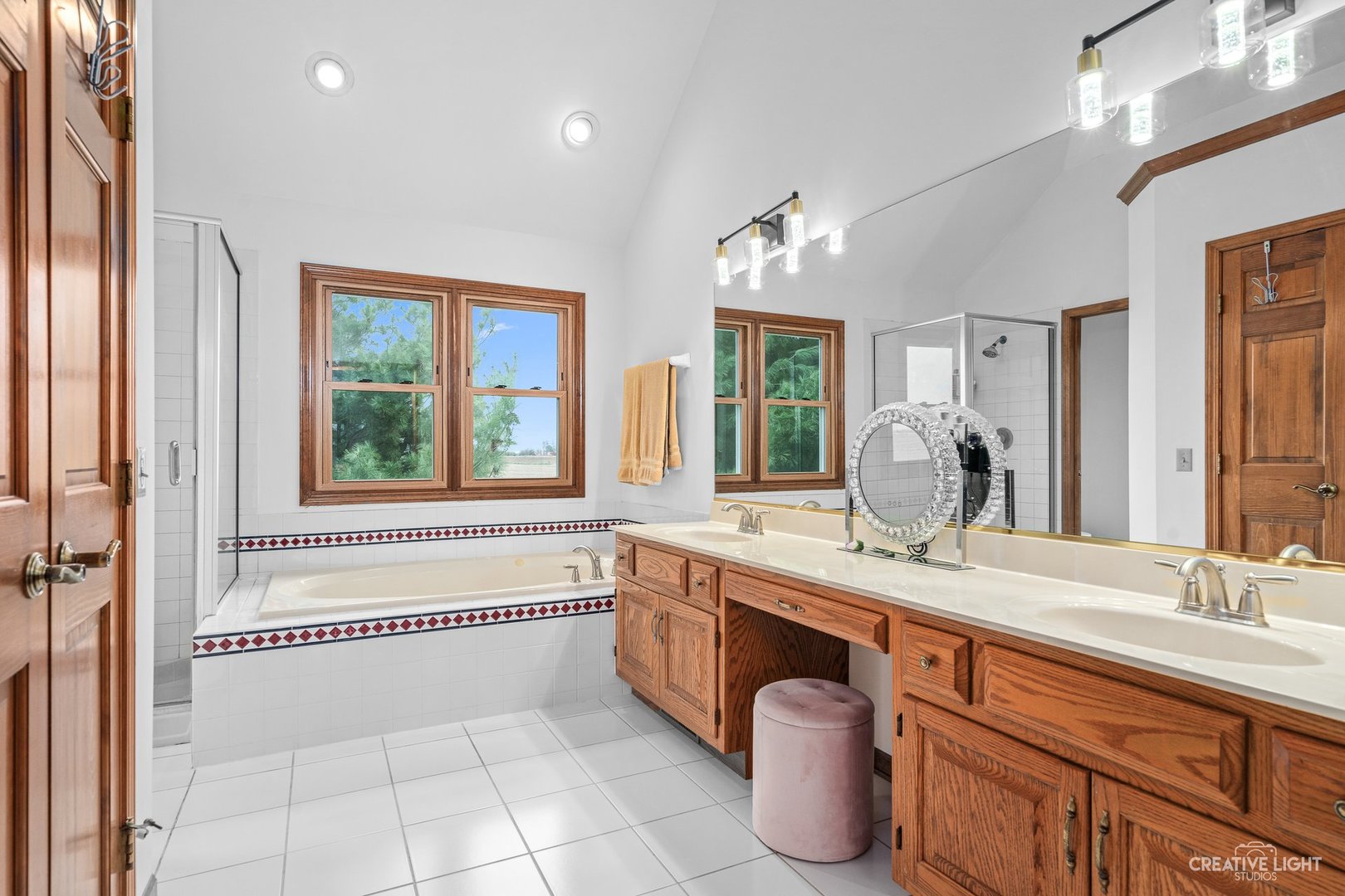 980 Eldamain Road Plano, IL 60545 - Photo 24 of 27 a spacious bathroom with a granite countertop double vanity sink a mirror and a bathtub