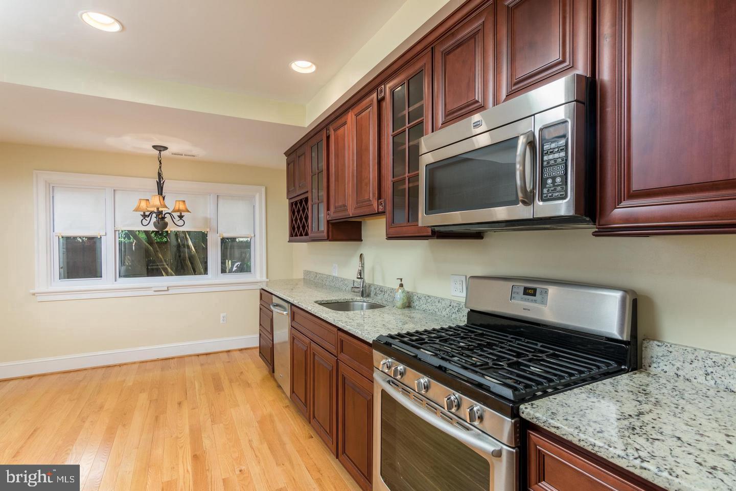 151 Duke Of Gloucester Street Annapolis, MD 21401 - Photo 12 of 28 a kitchen with stainless steel appliances granite countertop a stove a microwave and sink