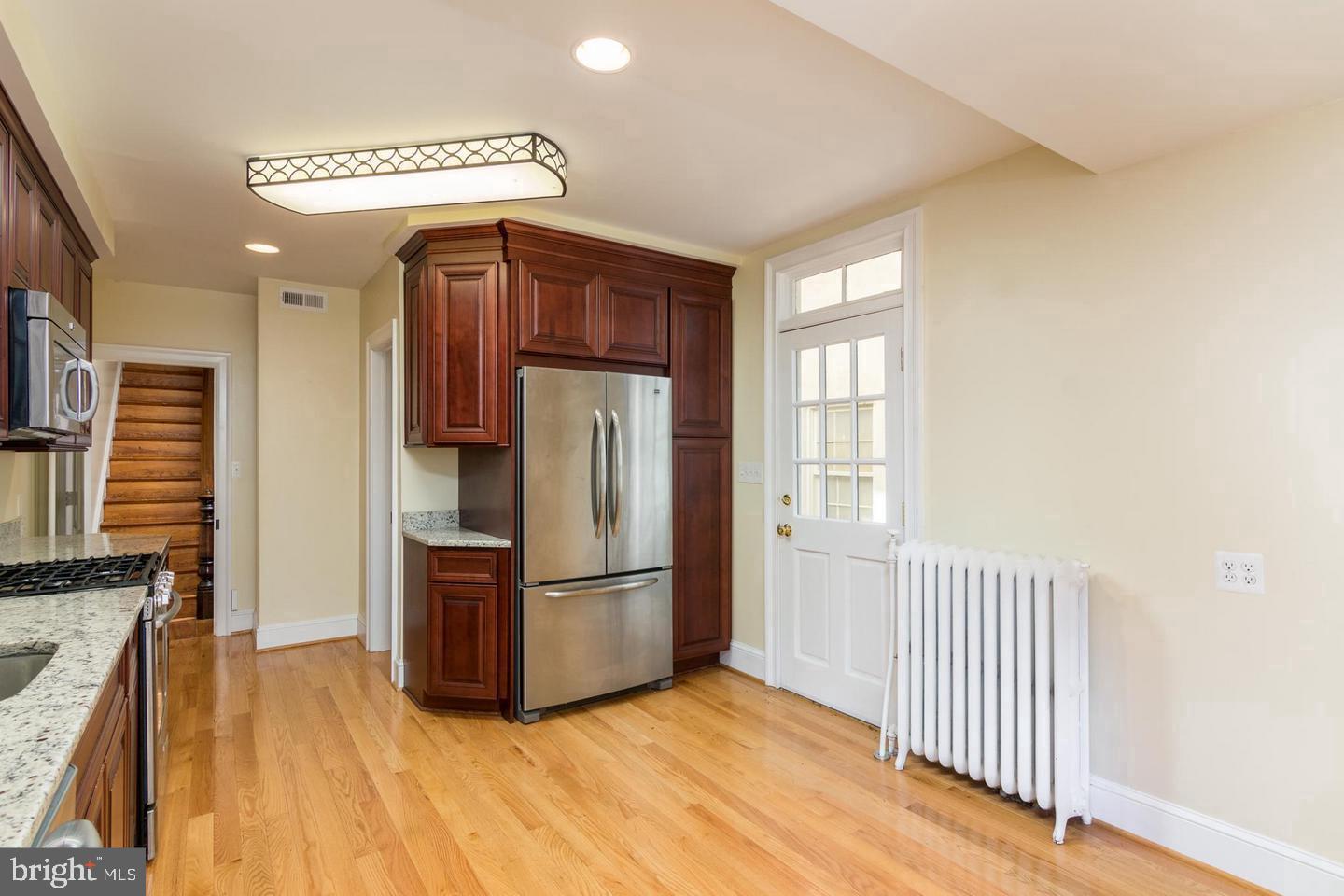151 Duke Of Gloucester Street Annapolis, MD 21401 - Photo 14 of 28 a kitchen with stainless steel appliances granite countertop a refrigerator and a stove top oven