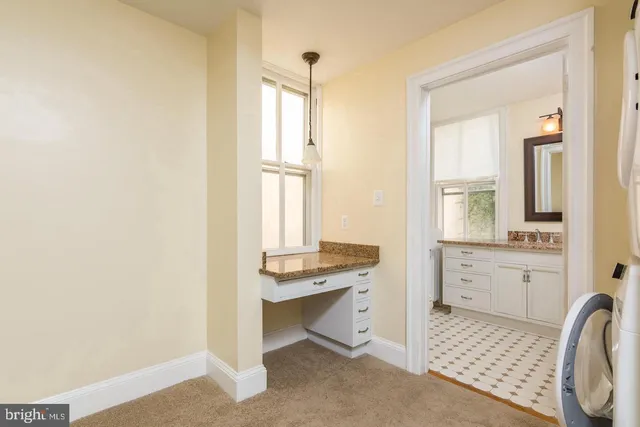 a room with a window and dresser