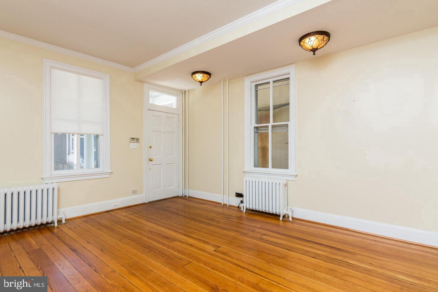 151 Duke Of Gloucester Street Annapolis, MD 21401 - Photo 5 of 28 a view of empty room with wooden floor and fan