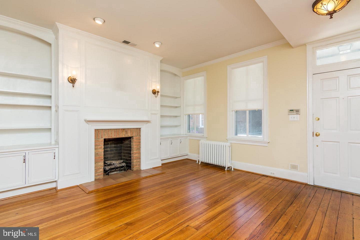 151 Duke Of Gloucester Street Annapolis, MD 21401 - Photo 6 of 28 a view of empty room with wooden floor and fireplace