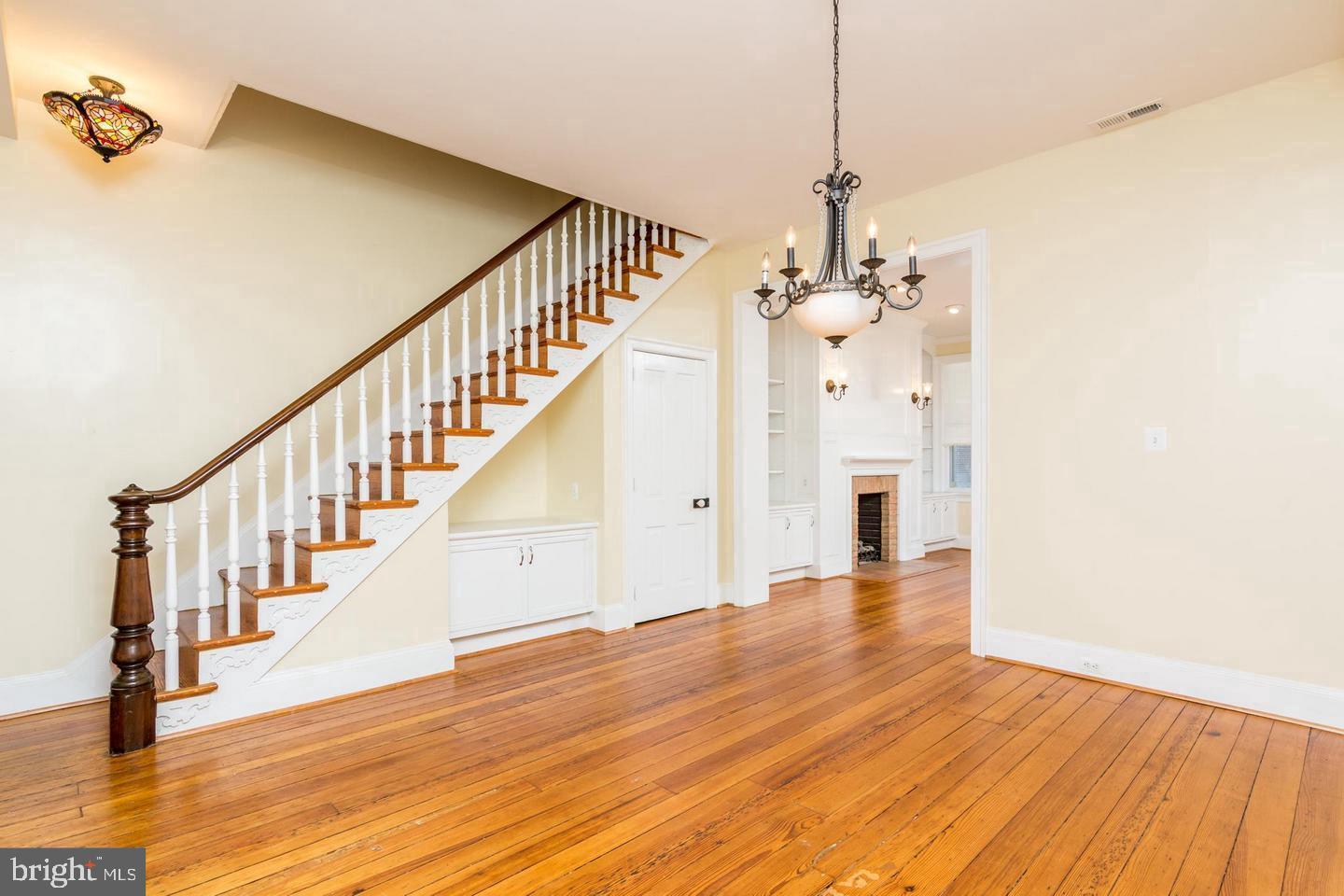 151 Duke Of Gloucester Street Annapolis, MD 21401 - Photo 9 of 28 a view of a hallway with wooden floor and staircase