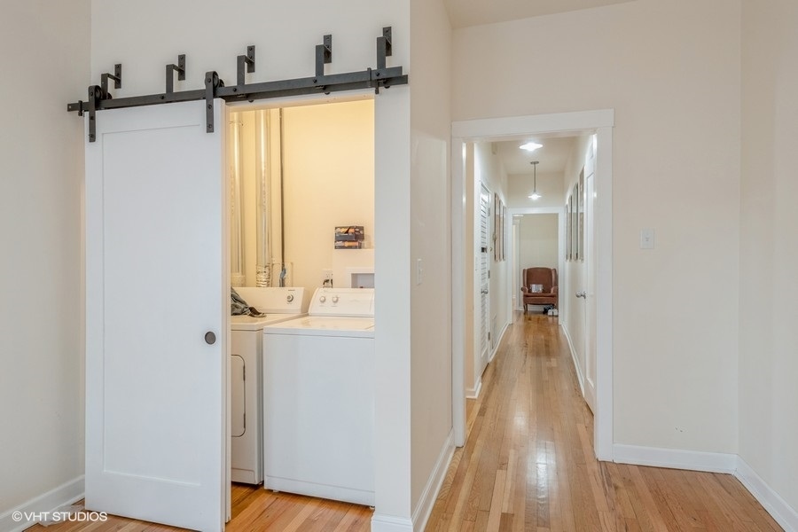 Undisclosed Address Chicago, IL 60641 - Photo 2 of 15 a view of a hallway with wooden floor and a bathroom