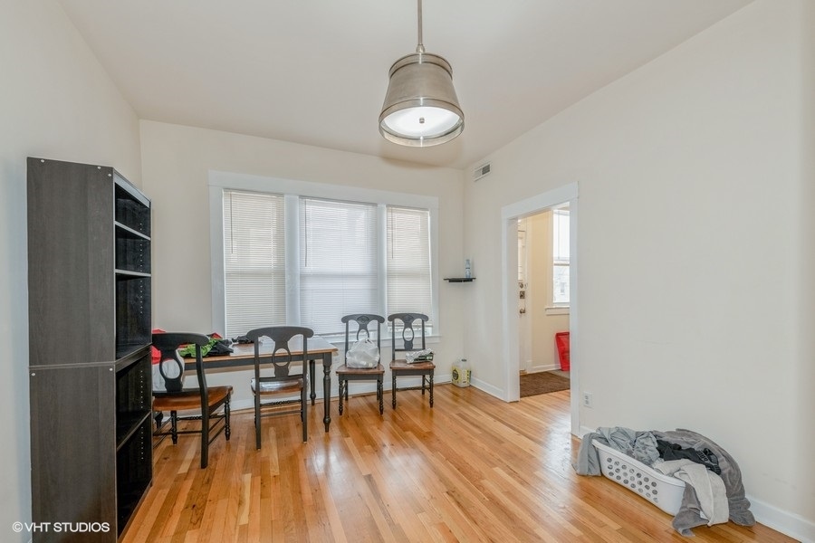 Undisclosed Address Chicago, IL 60641 - Photo 4 of 15 a view of a dining room with furniture and wooden floor