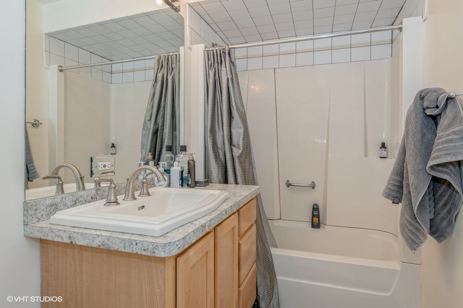 Undisclosed Address Chicago, IL 60641 - Photo 6 of 15 a bathroom with a granite countertop sink and a mirror