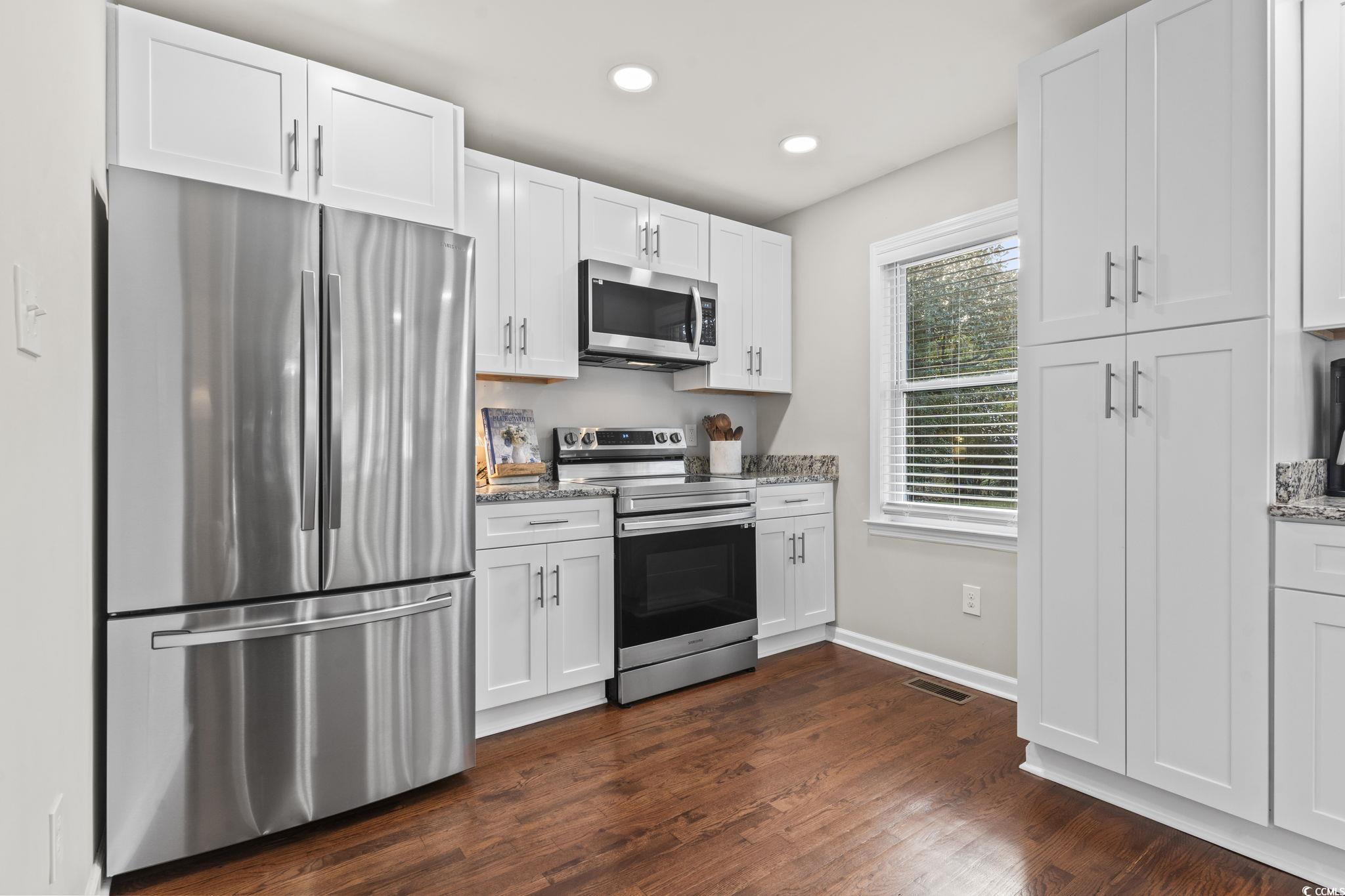 1673 Middleton Street Georgetown, SC 29440 - Photo 12 of 40 Kitchen featuring white cabinetry, light stone cou