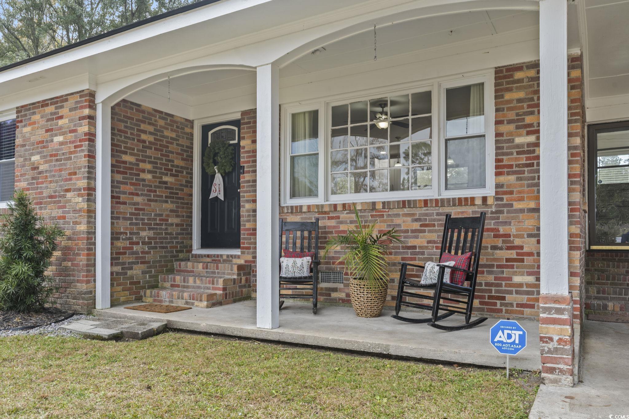 Entrance to property featuring a porch