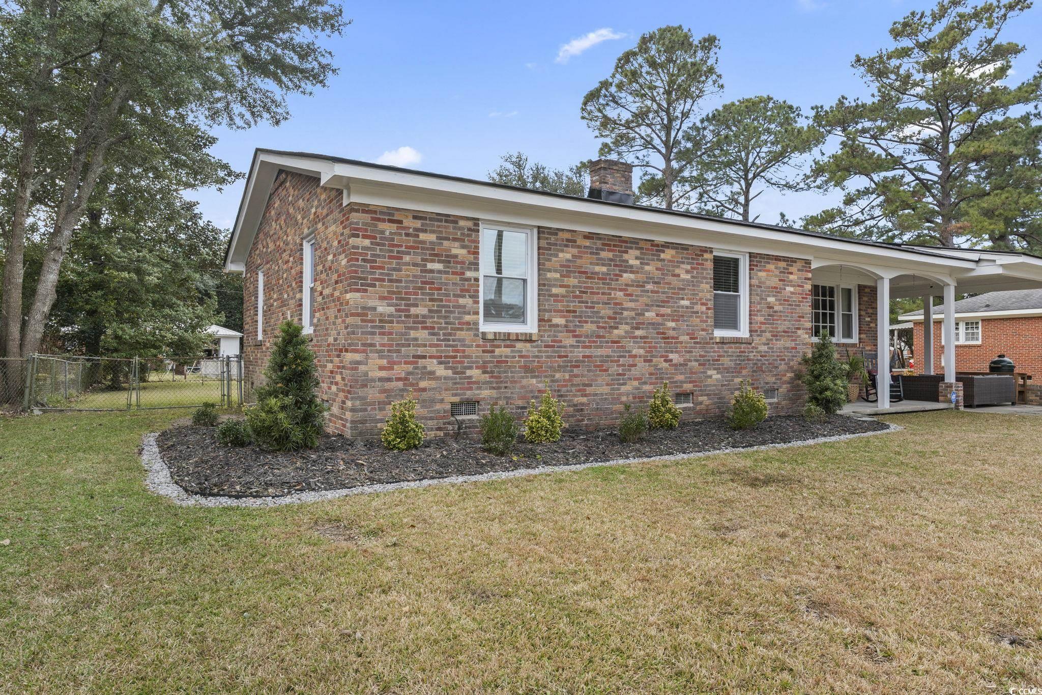 1673 Middleton Street Georgetown, SC 29440 - Photo 35 of 40 View of property exterior with a lawn and covered