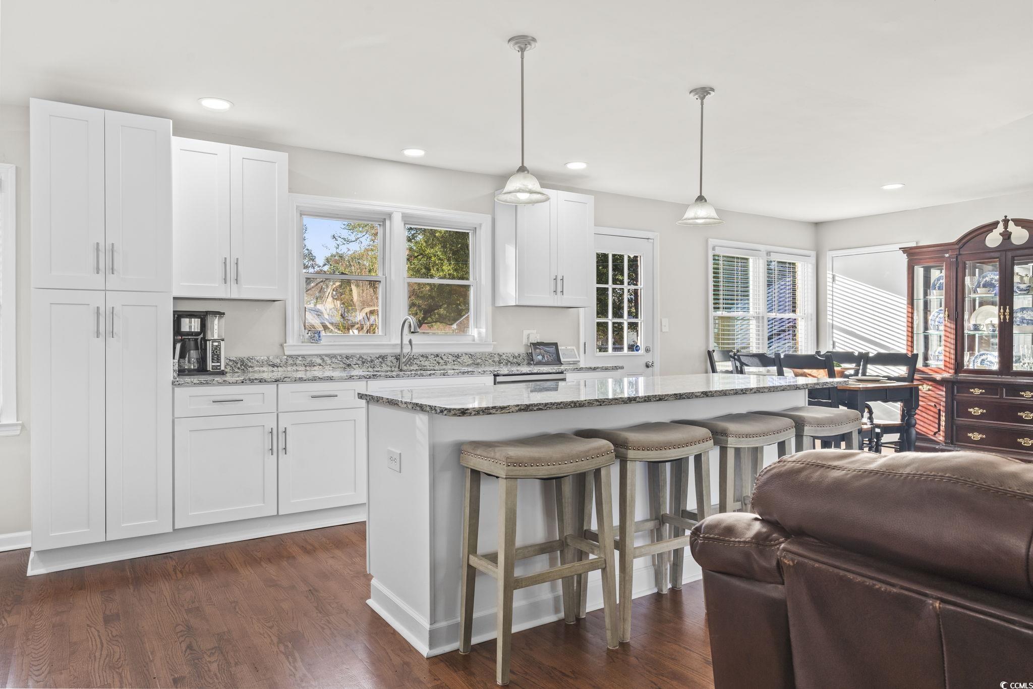Kitchen featuring a center island, dark wood-type