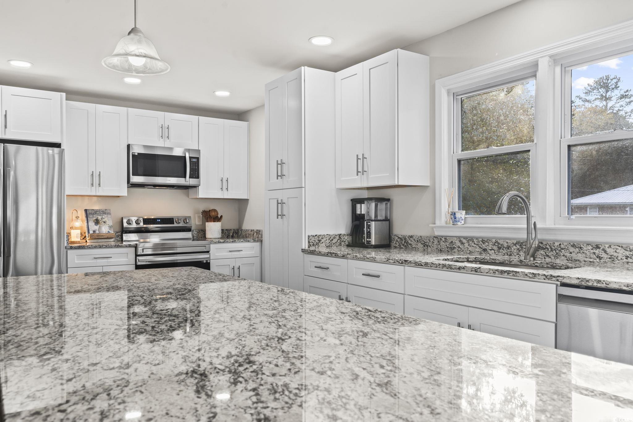 1673 Middleton Street Georgetown, SC 29440 - Photo 9 of 40 Kitchen featuring white cabinetry, sink, light sto