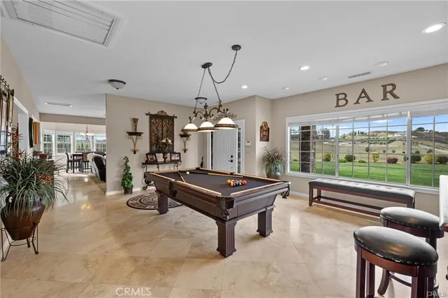 a view of a dining room with furniture large windows and wooden floor