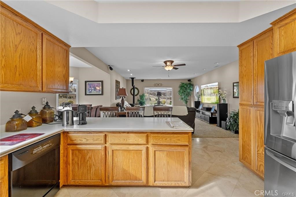 39581 Sperry Court Temecula, CA 92591 - Photo 21 of 63 a view of a kitchen with stainless steel appliances granite countertop a sink and cabinets